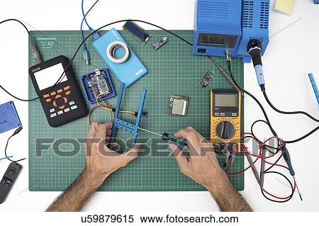 Stock Photography - Assembling electronic device.. Fotosearch