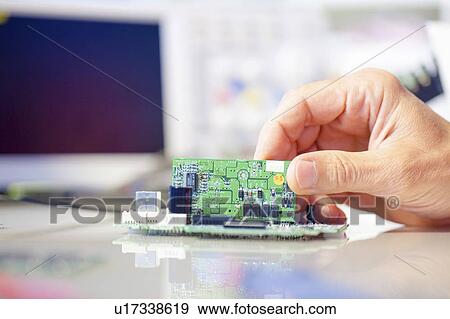 Stock Photo - Assembling electronics device.. Fotosearch