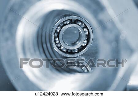 Stock Photo - Ball bearing seen through a steel bolt.. Fotosearch