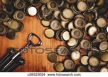 Beer bottle tops and opener. View Large Photo Image Picture - Beer bottle tops and opener.. Fotosearch