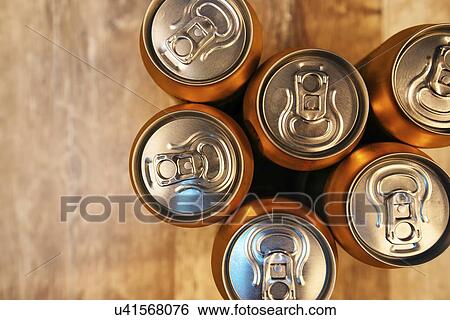 Stock Photograph - Beer cans on rustic wooden table, top view.. Fotosearch