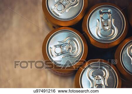 Stock Photograph - Beer cans on rustic wooden table, top view.. Fotosearch