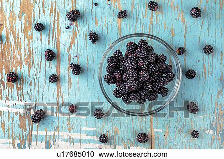 Stock Image - Blackberries in glass bowl, top view.. Fotosearch