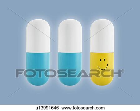 Stock Photograph - Blue, yellow and white capsule, studio shot.. Fotosearch