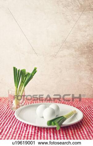 Stock Image - Boiled eggs and spring onions.. Fotosearch