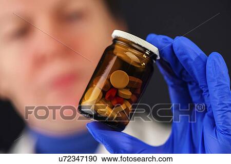 Stock Image - Bottle of unlabelled pills.. Fotosearch