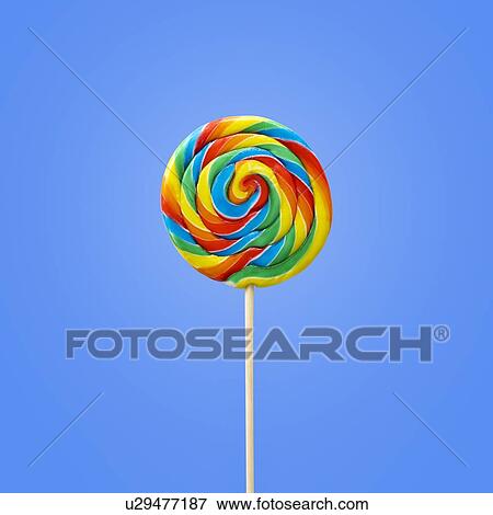 Stock Photo - Bright coloured lollipop against a blue background.. Fotosearch