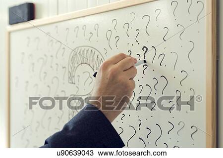 Businessman writing question marks on office whiteboard. View Large Photo Image Stock Image - Businessman writing question marks on office whiteboard.. Fotosearch