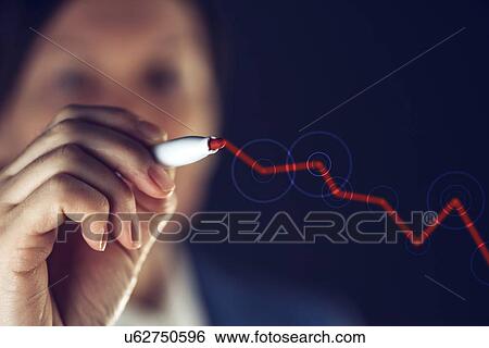 Stock Photograph - Businesswoman drawing rising graph.. Fotosearch