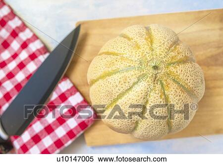 Cantaloupe melon and knife on rustic wooden table. View Large Photo Image Stock Photography - Cantaloupe melon and knife on rustic wooden table.. Fotosearch