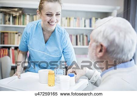 Care worker and senior man with medicine bottles. View Large Photo Image Stock Photography - Care worker and senior man with medicine bottles.. Fotosearch