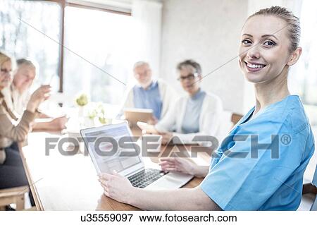 Care worker with laptop in care home, portrait. View Large Photo Image Stock Photo - Care worker with laptop in care home, portrait.. Fotosearch