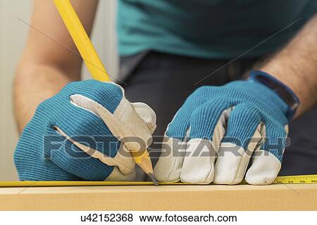 Carpenter measuring wood. View Large Photo Image Stock Photo - Carpenter measuring wood.. Fotosearch