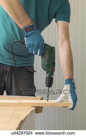 Carpenter using electric drill. View Large Photo Image Picture - Carpenter using electric drill.. Fotosearch