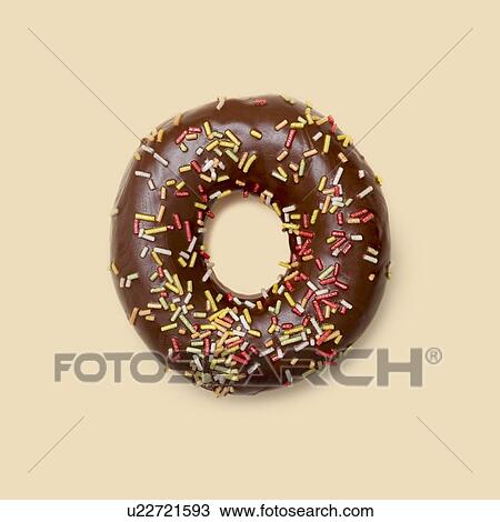 Stock Image - Chocolate doughnut with sugar strands, studio shot.. Fotosearch