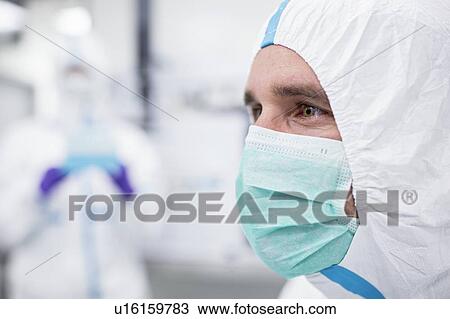 Close-up of a lab technician wearing a protective suit and face mask in a laboratory that must maintain a sterile environment. View Large Photo Image Stock Image - Close-up of a lab technician wearing a protective suit and face mask in a laboratory that must maintain a sterile environment.. Fotosearch