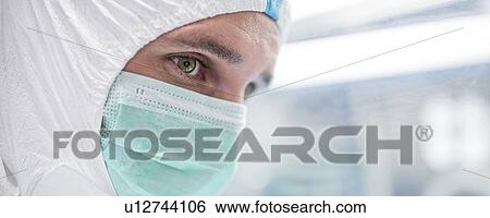 Close-up of a lab technician wearing a protective suit and face mask in a laboratory that must maintain a sterile environment. View Large Photo Image Stock Photograph - Close-up of a lab technician wearing a protective suit and face mask in a laboratory that must maintain a sterile environment.. Fotosearch