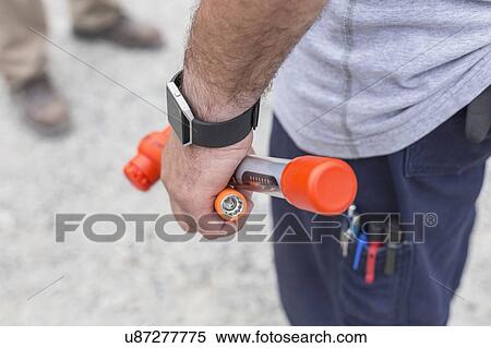 Stock Photography - Close-up of an engineer holding a torque wrench.. Fotosearch