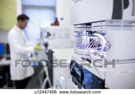 Stock Photograph - Close-up of modules of a liquid chromatography machine. At centre right is a temperature-controlled column compartment used to heat or cool the samples. Liquid chromatography is used to separate compounds from a mixture of compounds dissolved in a liquid.. Fotosearch