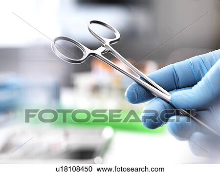 Stock Image - Close-up of surgical scissors in an operating theatre.. Fotosearch