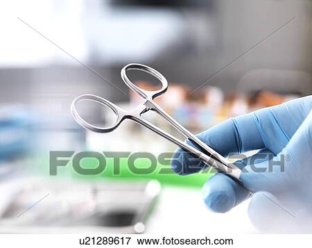 Stock Photo - Close-up of surgical scissors in an operating theatre.. Fotosearch