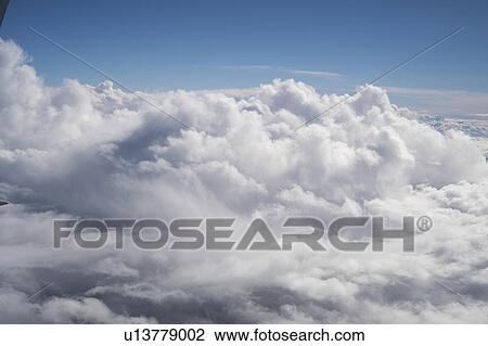 Stock Image - Clouds from aeroplane window.. Fotosearch