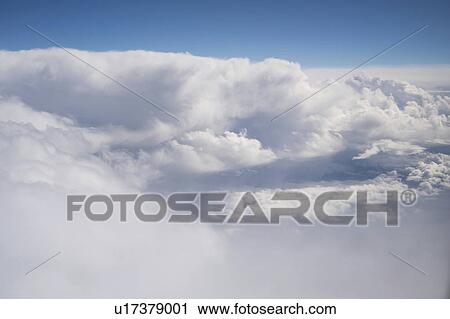 Stock Image - Clouds from aeroplane window.. Fotosearch