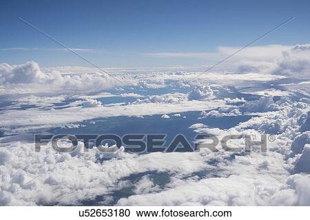 Stock Image - Clouds from aeroplane window.. Fotosearch