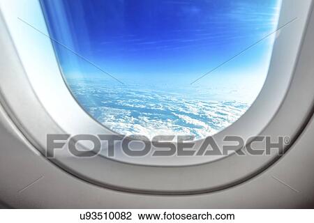 Stock Image - Clouds from aeroplane window.. Fotosearch