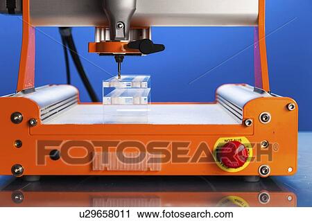 Stock Image - CNC milling machine drilling plastic block#.. Fotosearch