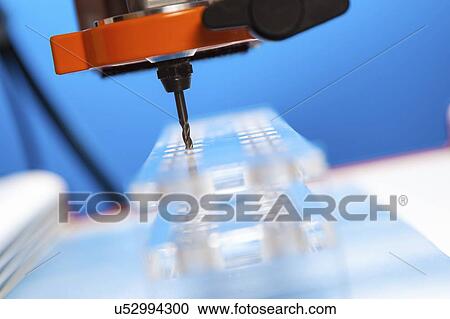 Stock Image - CNC milling machine drilling plastic block#.. Fotosearch