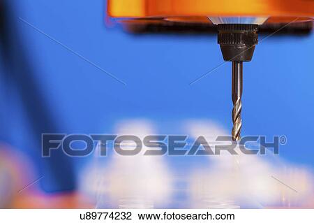 Stock Image - CNC milling machine drilling plastic block#.. Fotosearch