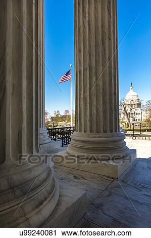 Columns of Supreme Court offers view of US Capitol View Large Photo Image Stock Image - Columns of Supreme Court offers view of US Capitol. Fotosearch