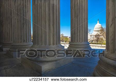 Columns of Supreme Court offers view of US Capitol View Large Photo Image Stock Photo - Columns of Supreme Court offers view of US Capitol. Fotosearch