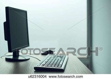 Picture - Desktop PC in empty office.. Fotosearch