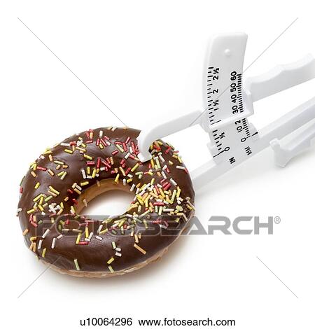 Stock Photograph - Dieting, conceptual image. Chocolate doughnut with skin fold caliper.. Fotosearch