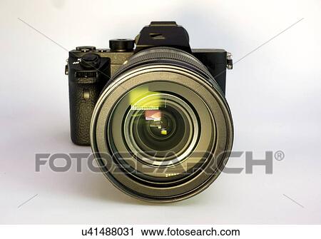 Stock Image - Digital mirrorless camera with zoom lens.. Fotosearch