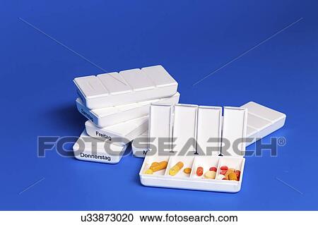 Stock Image - Dispenser with tablets.. Fotosearch