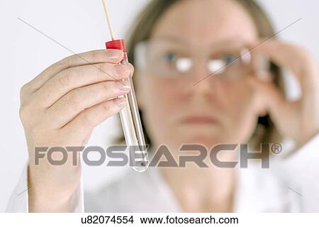 Picture - Doctor holding swab sample.. Fotosearch