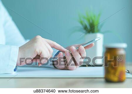 Doctor using smartphone. View Large Photo Image Stock Image - Doctor using smartphone.. Fotosearch