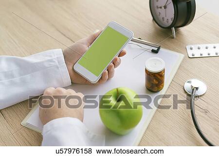 Doctor using smartphone. View Large Photo Image Stock Photo - Doctor using smartphone.. Fotosearch