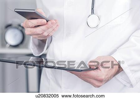 Doctor using smartphone. View Large Photo Image Stock Photography - Doctor using smartphone.. Fotosearch