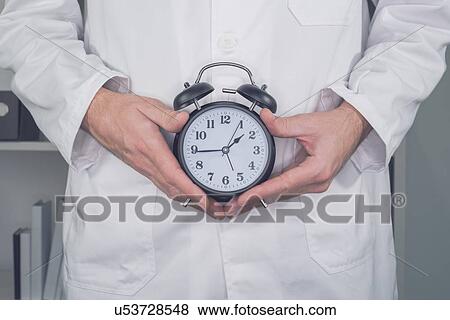 Doctor with alarm clock, conceptual image. View Large Photo Image Stock Photo - Doctor with alarm clock, conceptual image.. Fotosearch