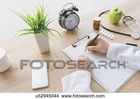 Picture - Doctor writing notes.. Fotosearch