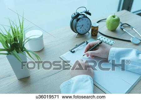 Stock Image - Doctor writing notes.. Fotosearch