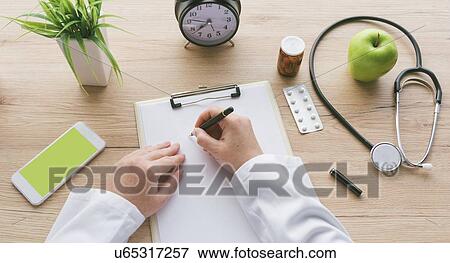 Doctor writing notes. View Large Photo Image Stock Photo - Doctor writing notes.. Fotosearch