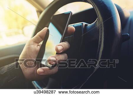 Driver using smartphone. View Large Photo Image Stock Photo - Driver using smartphone.. Fotosearch