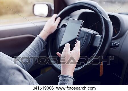 Stock Photograph - Driver using smartphone.. Fotosearch