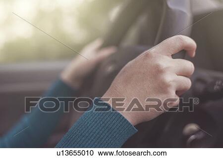 Driver's hands on steering wheel, close-up. View Large Photo Image Stock Image - Driver's hands on steering wheel, close-up.. Fotosearch