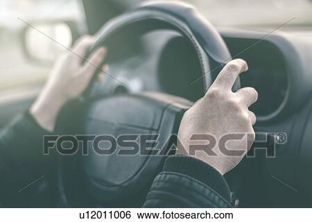 Driver's hands on steering wheel, close-up. View Large Photo Image Stock Photograph - Driver's hands on steering wheel, close-up.. Fotosearch